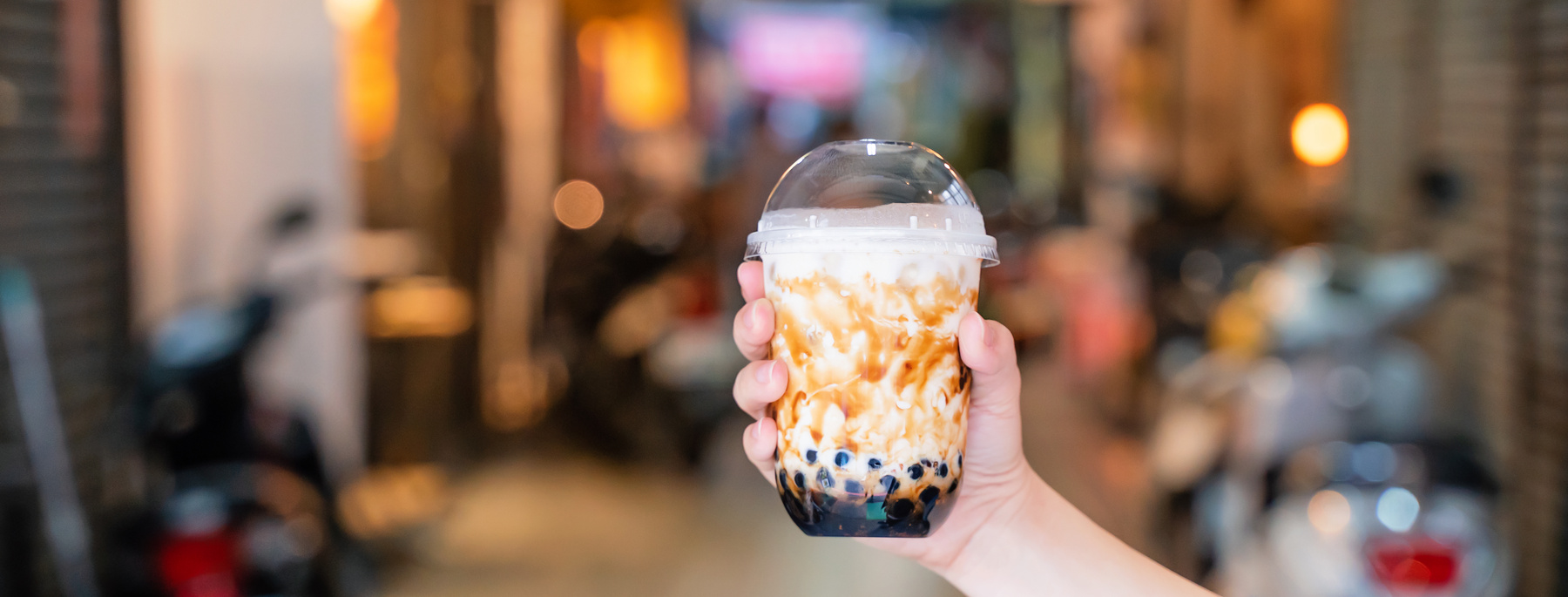 Woman Holding a Cup of Milk Tea